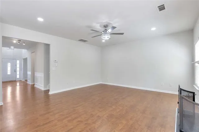 wooden floor in an empty room with a window