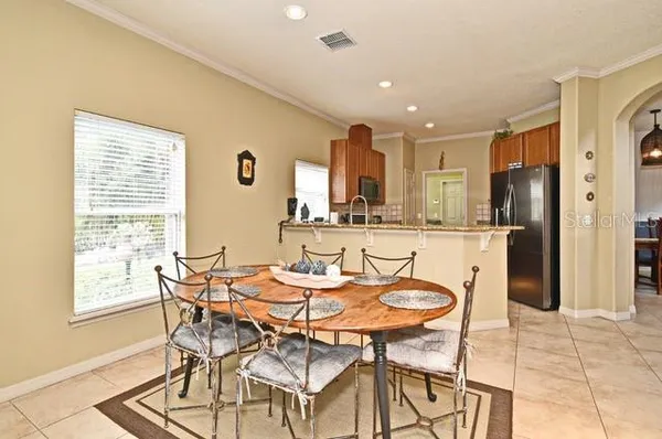 a living room with furniture a flat screen tv and a large window