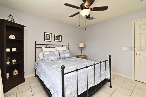 a bedroom with a bed and a chandelier