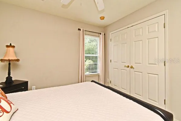 a bedroom with bed and a window