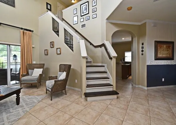 a kitchen with stainless steel appliances granite countertop a refrigerator a sink a stove a dining table and chairs