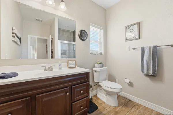 a bathroom with a toilet a sink and mirror