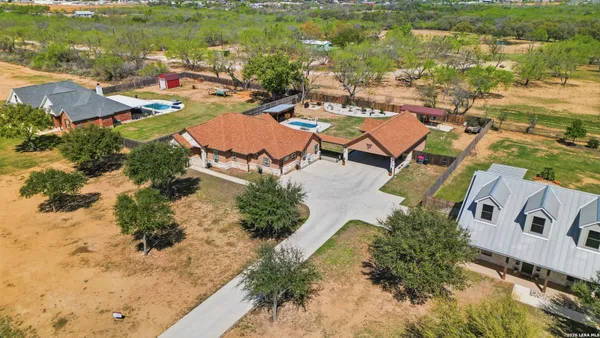 an aerial view of residential houses with outdoor space