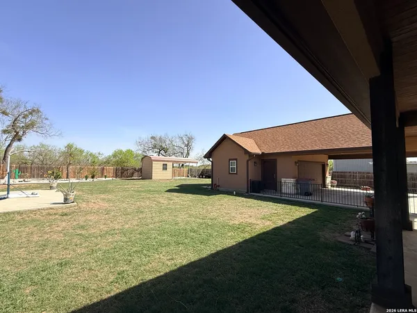 a view of a outdoor space with deck and tree