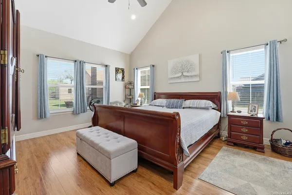 a bedroom with a bed couch and a large window