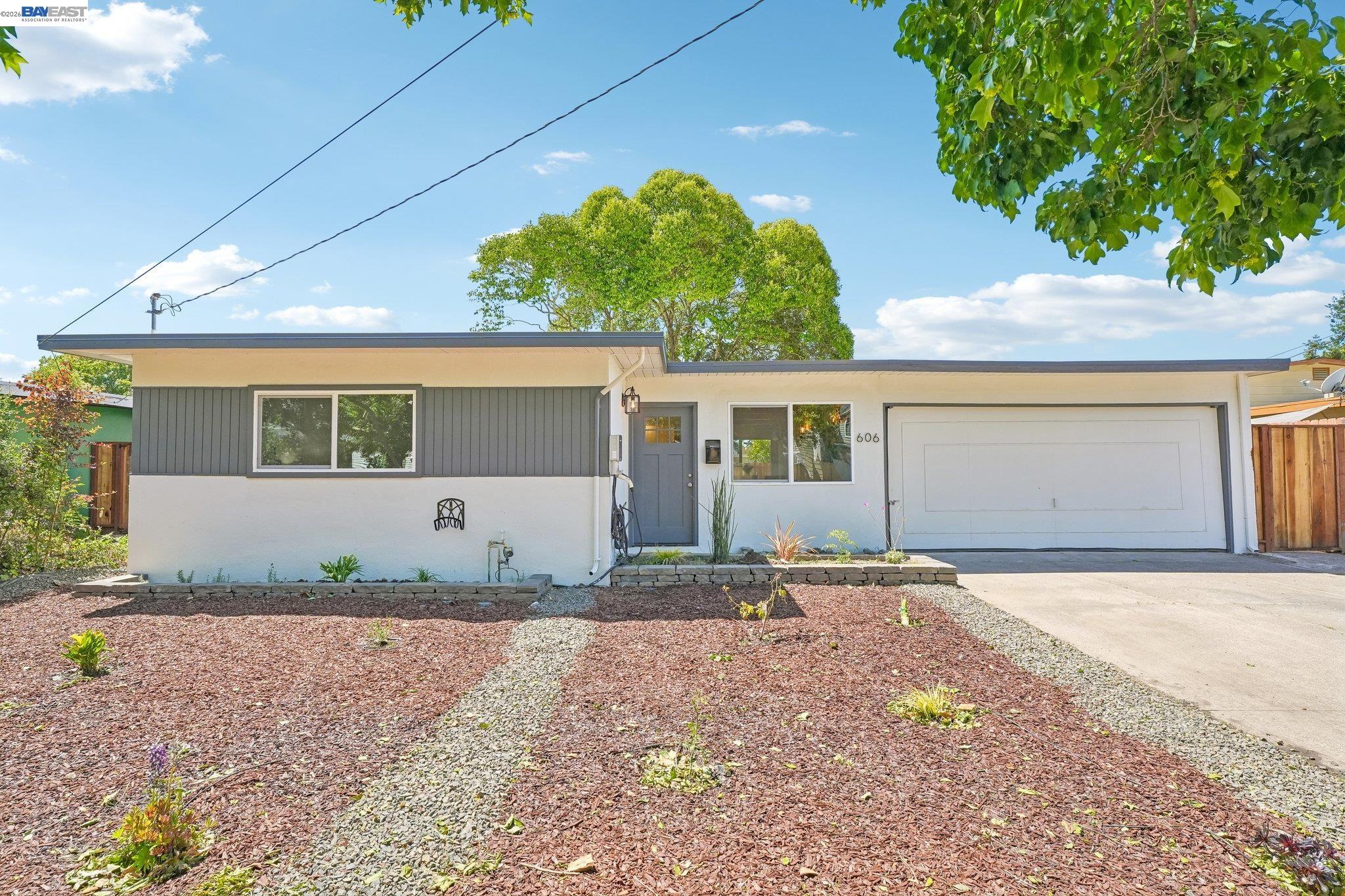 606 West 9th Street Santa Rosa, CA 95401 - Photo 5 of 52 a front view of a house with a yard and a garage