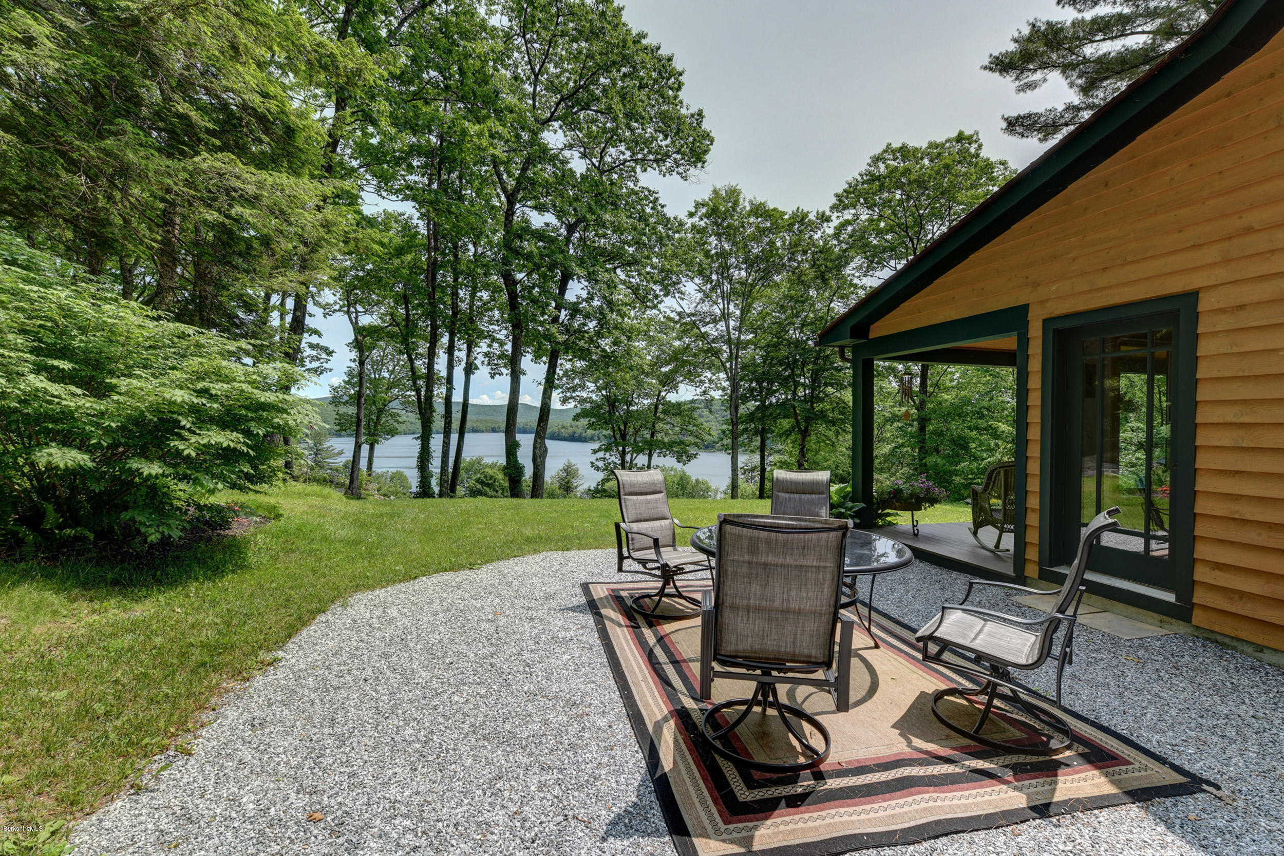 17A Goose Pond Road Tyringham, MA 01238 - Photo 19 of 29 a view of a patio with table and chairs potted plants and large tree
