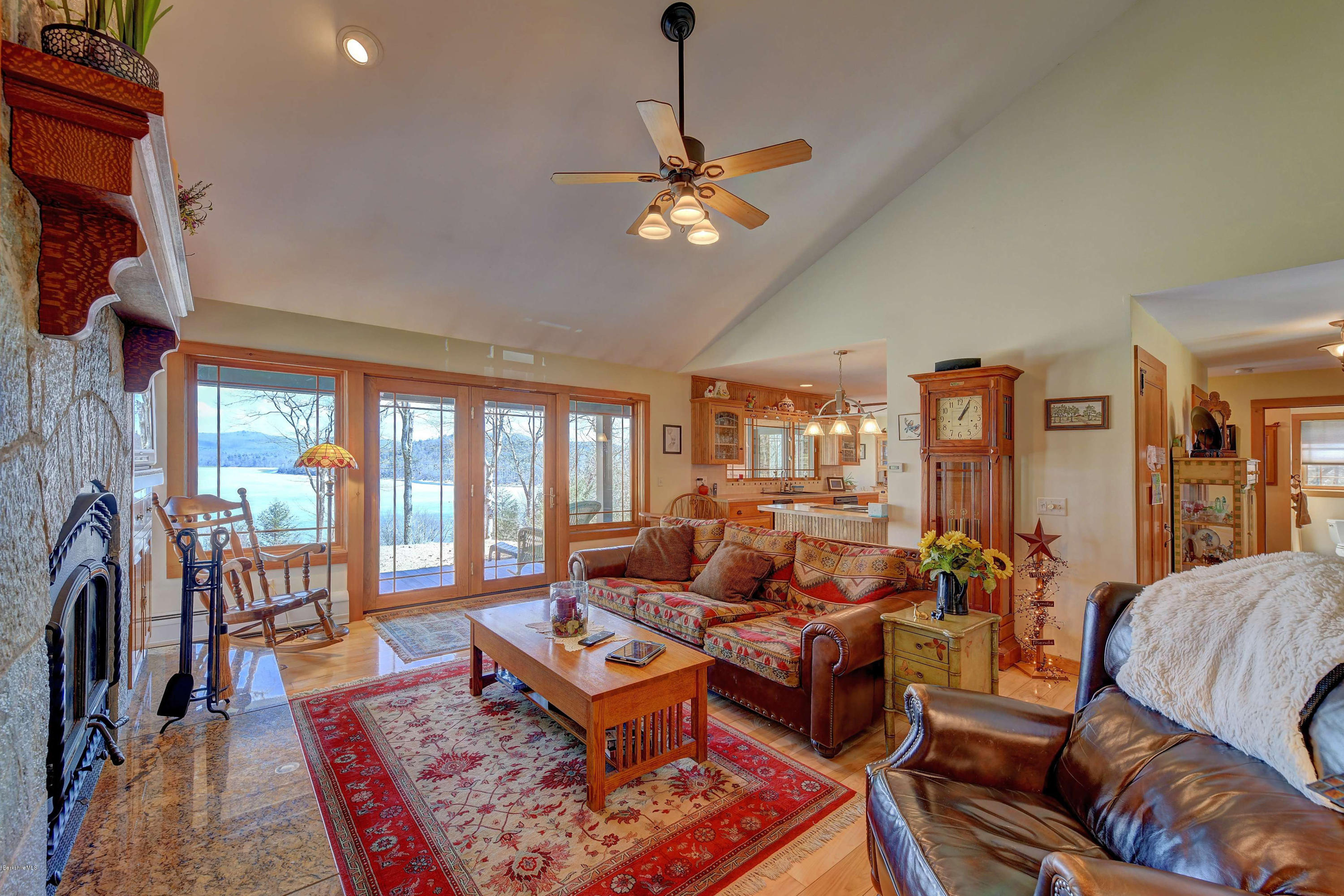 17A Goose Pond Road Tyringham, MA 01238 - Photo 4 of 29 a living room with furniture a flat screen tv and a floor to ceiling window