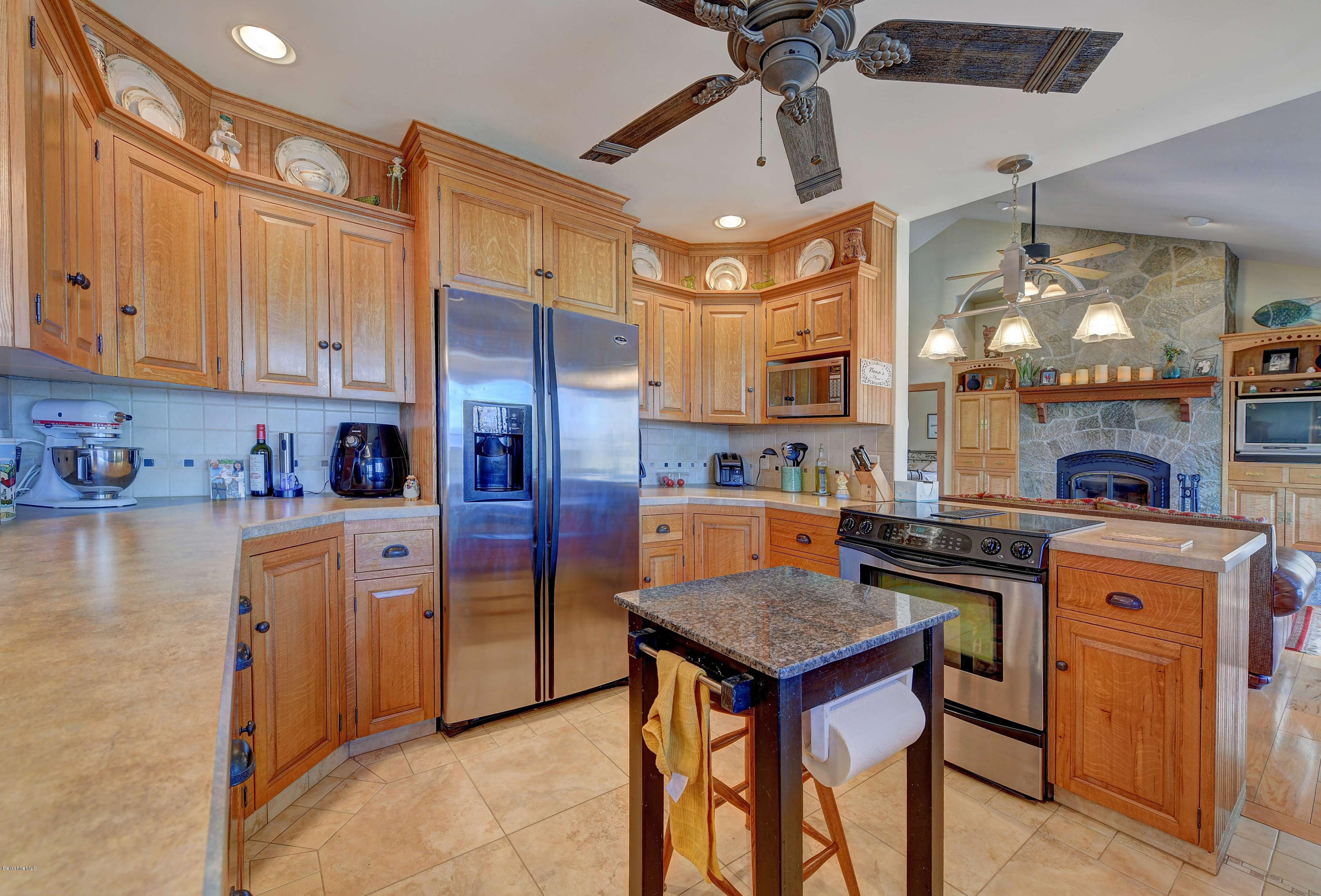 17A Goose Pond Road Tyringham, MA 01238 - Photo 6 of 29 a kitchen with stainless steel appliances granite countertop a stove refrigerator and cabinets