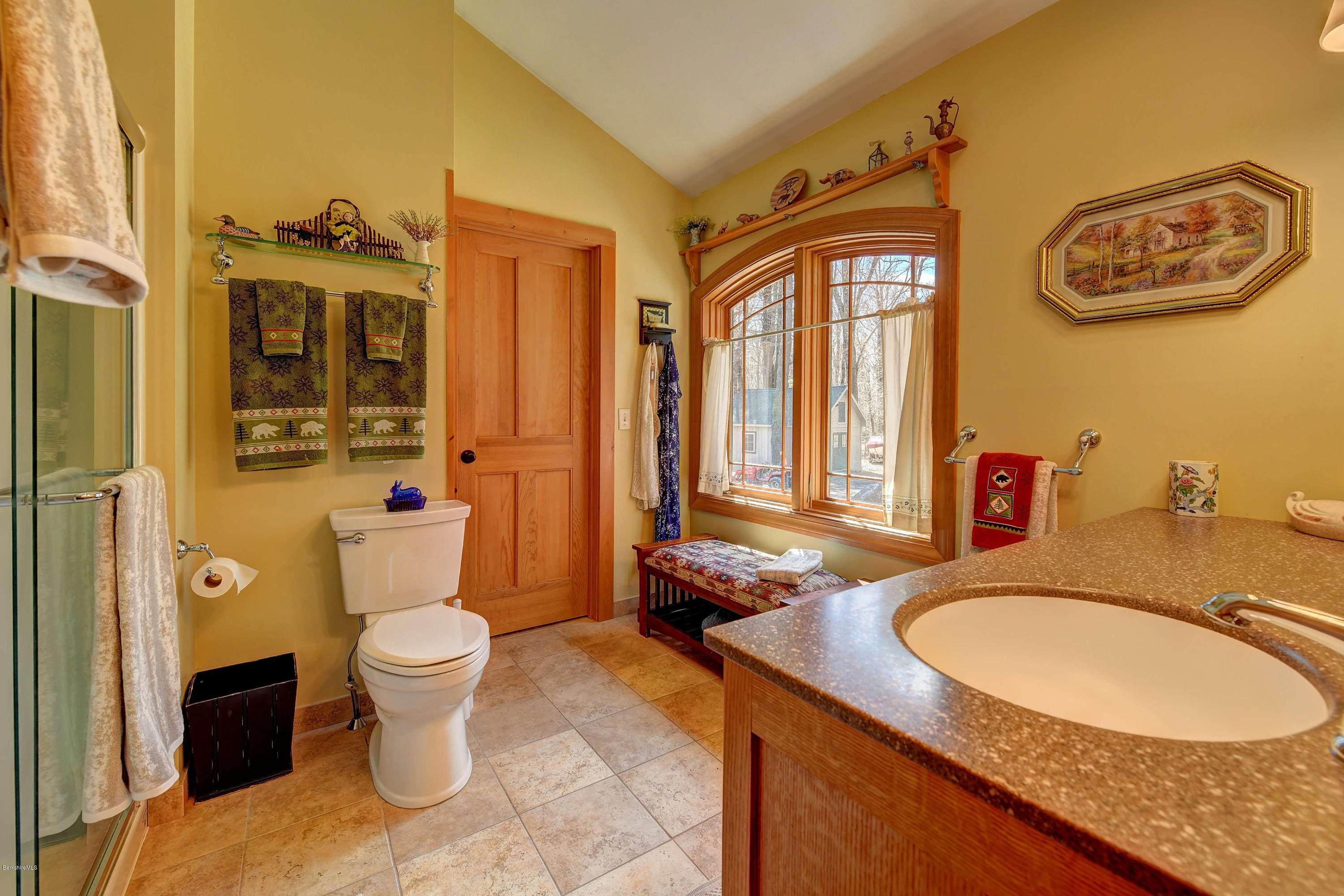 17A Goose Pond Road Tyringham, MA 01238 - Photo 9 of 29 a bathroom with a granite countertop toilet a sink and a mirror