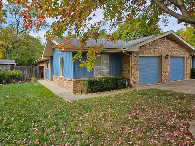 a front view of a house with a garden and yard