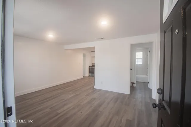 a white bath tub sitting next to a white sink and a toilet