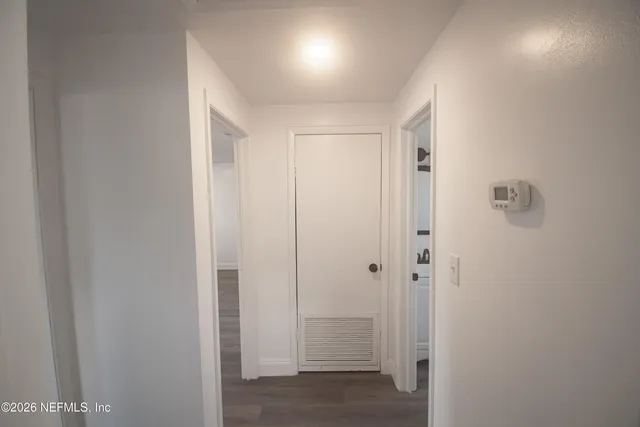 an empty room with wooden floor and a window