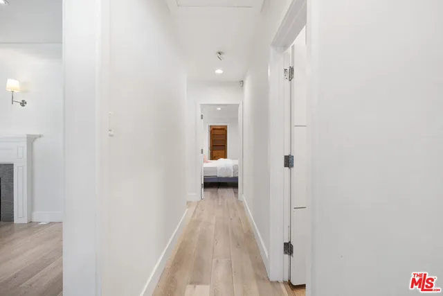 a view of a hallway with wooden shelves