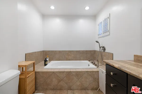 a bathroom with a bathtub and shower