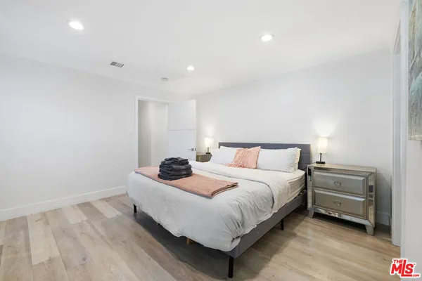 a bedroom with a bed and a dresser