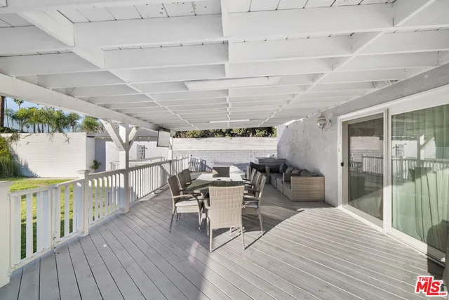 a dining room with wooden floor a table and chairs