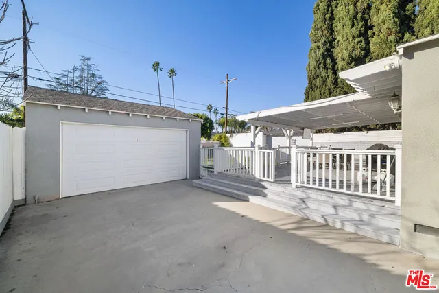 a view of a house with a garage and yard