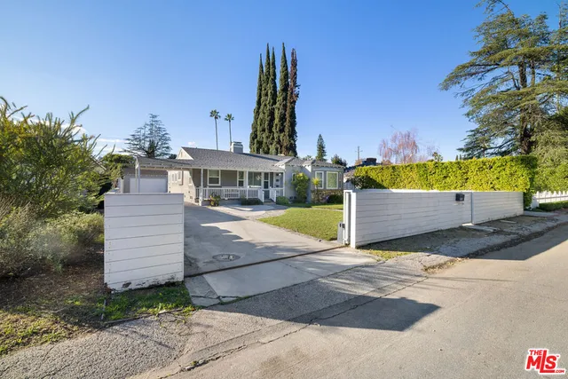 a view of a terrace with a garden and deck