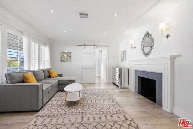 a living room with furniture a fireplace and a chandelier