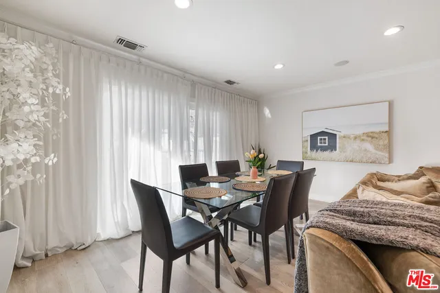 a view of a dining room with furniture and a window