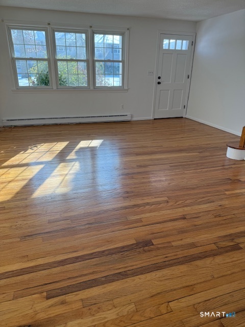 280 East Main Street, Unit E2 Clinton, CT 06413 - Photo 2 of 20 The front door to the living room and three windows to the left letting in natural light.
