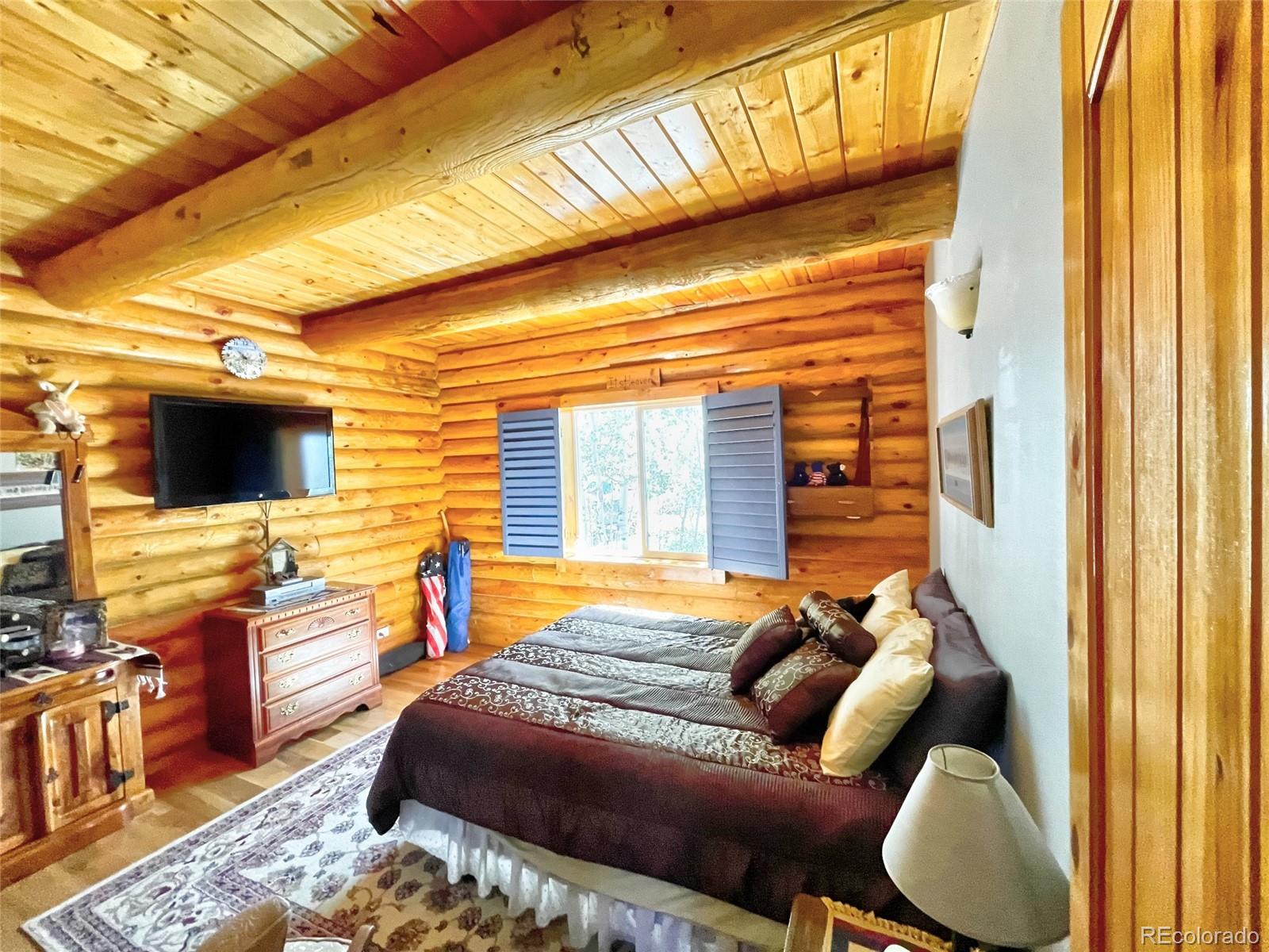 43 Pintail Road Como, CO 80432 - Photo 14 of 34 a bedroom with furniture and a flat screen tv