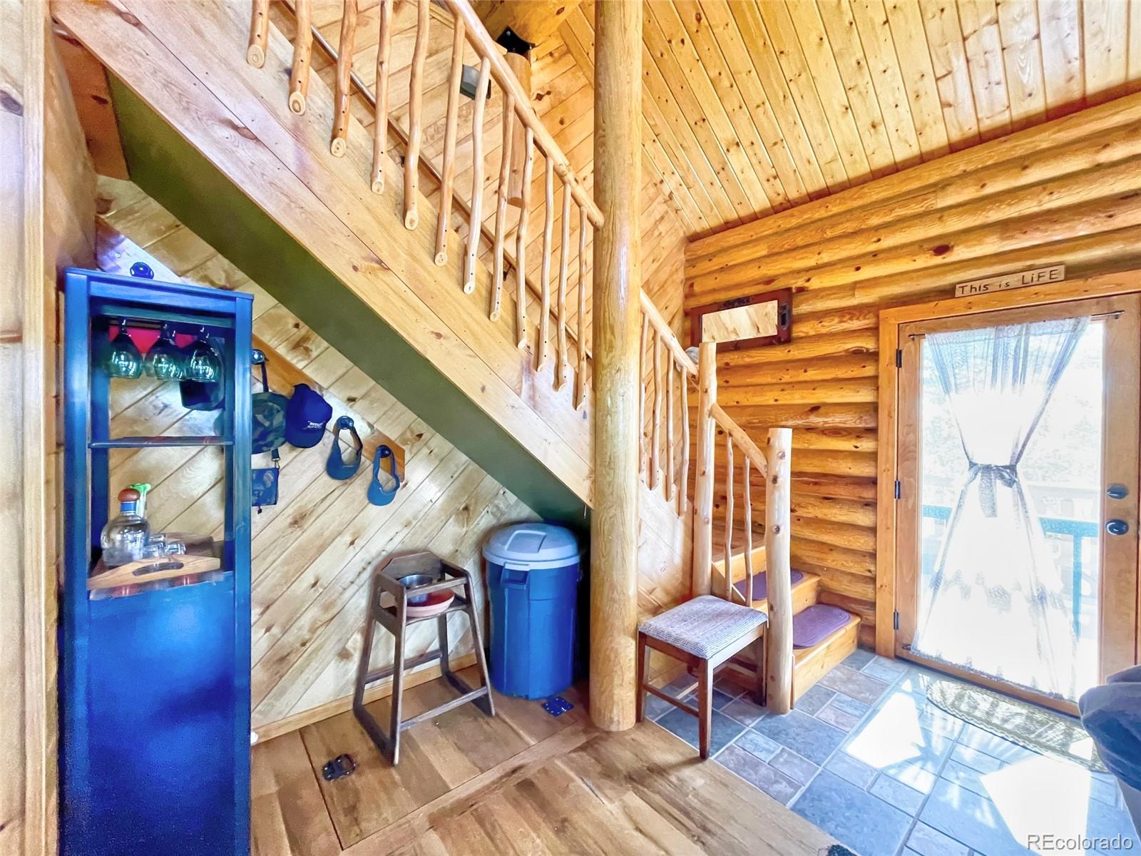 43 Pintail Road Como, CO 80432 - Photo 10 of 34 a front view of a house with outdoor seating and wooden floor