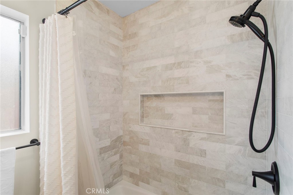 11339 Cecilia Street Downey, CA 90241 - Photo 11 of 17 a bathroom with a glass shower door