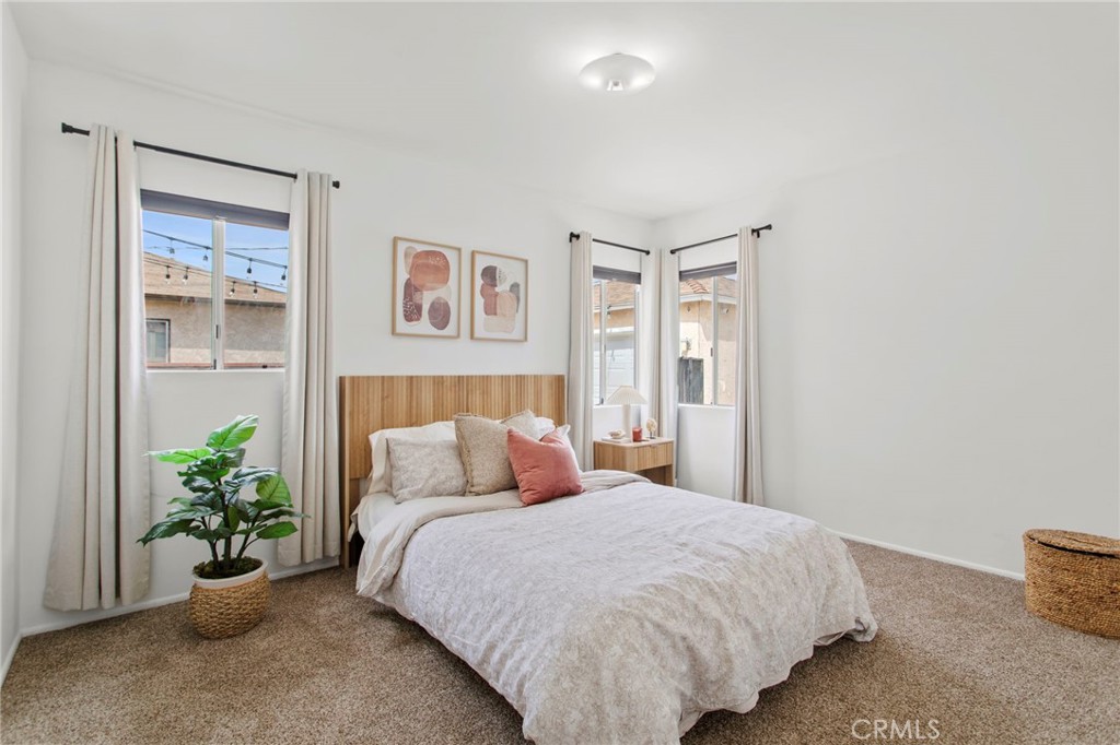11339 Cecilia Street Downey, CA 90241 - Photo 12 of 17 a bedroom with a bed and a potted plant