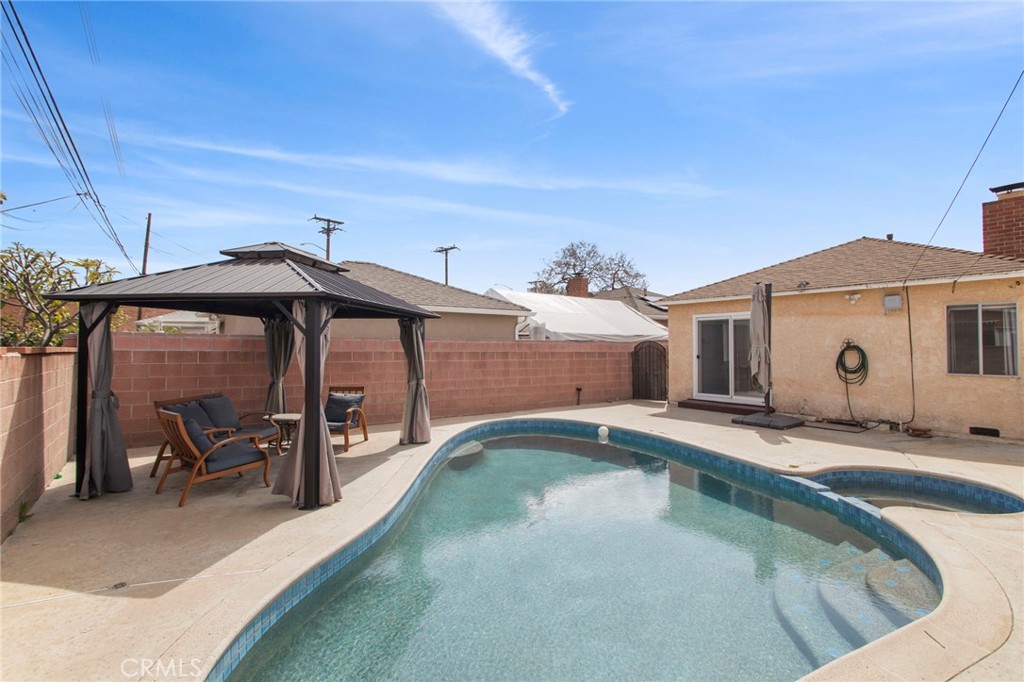11339 Cecilia Street Downey, CA 90241 - Photo 14 of 17 a view of a patio with table and chairs under an umbrella