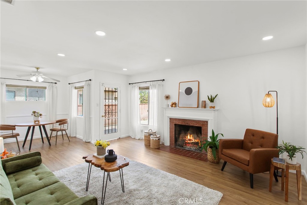 11339 Cecilia Street Downey, CA 90241 - Photo 3 of 17 a living room with furniture and a fireplace
