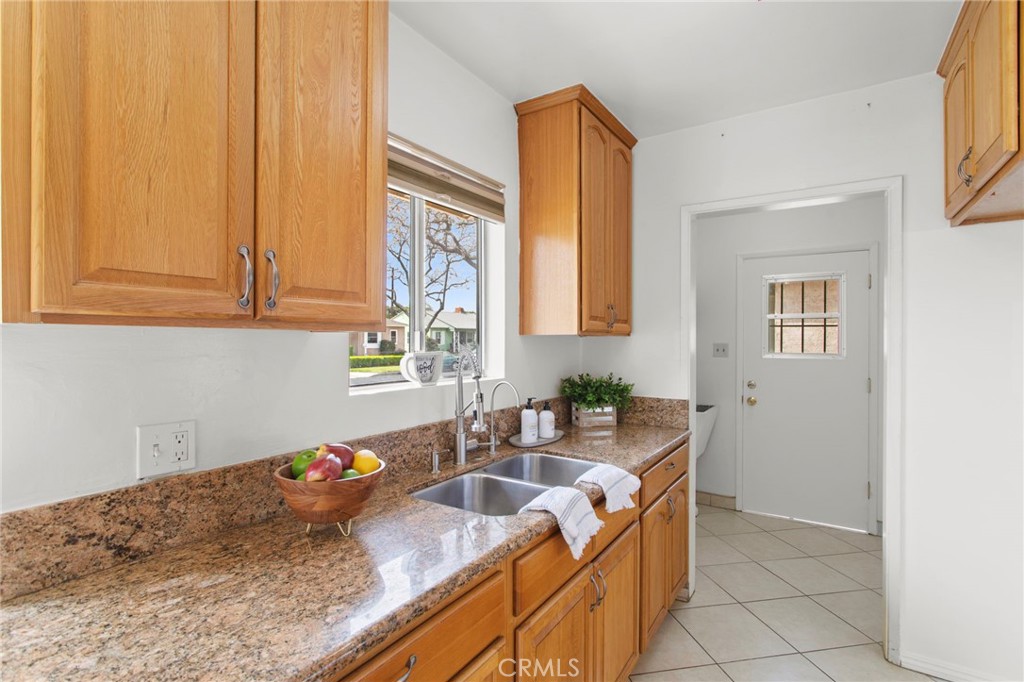 11339 Cecilia Street Downey, CA 90241 - Photo 8 of 17 a kitchen with granite countertop a sink and a stove
