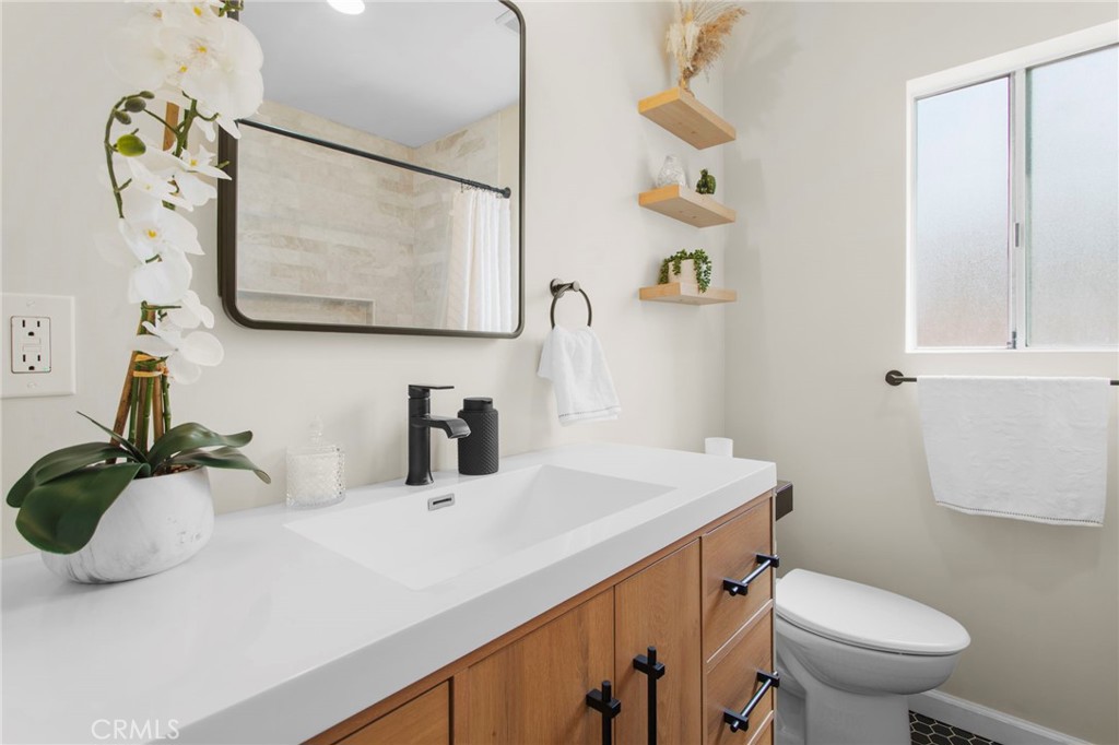 11339 Cecilia Street Downey, CA 90241 - Photo 10 of 17 a bathroom with a sink mirror and toilet