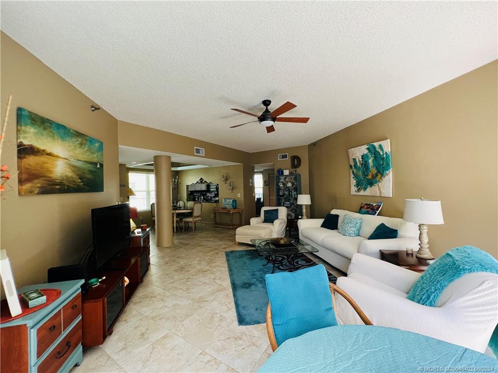 221 Northeast Plantation Road, Unit 215 Stuart, FL 34996 - Photo 18 of 83 a living room with furniture and a flat screen tv