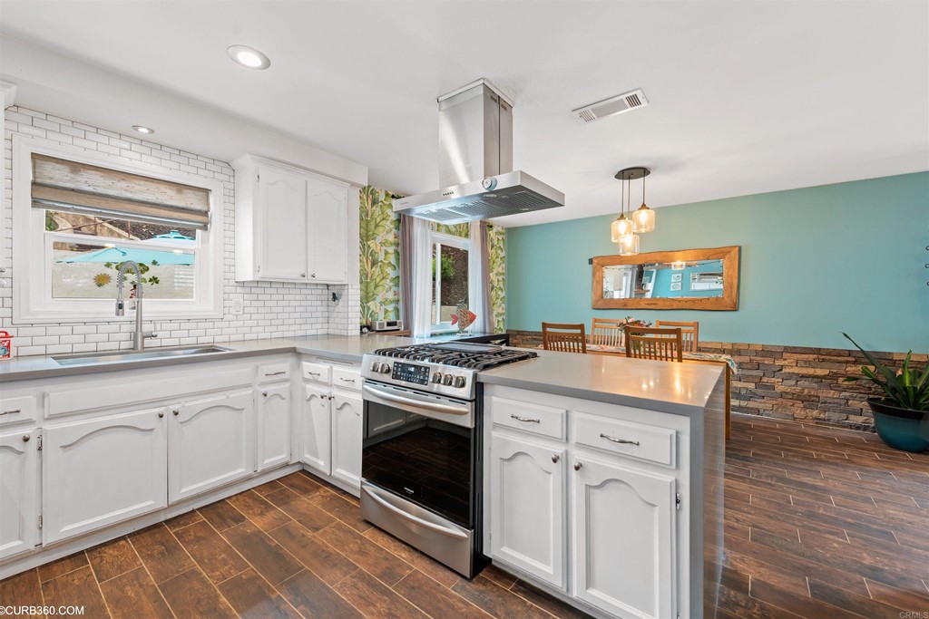 1179 Patricia Circle Vista, CA 92084 - Photo 12 of 48 a kitchen with a stove a sink and a refrigerator