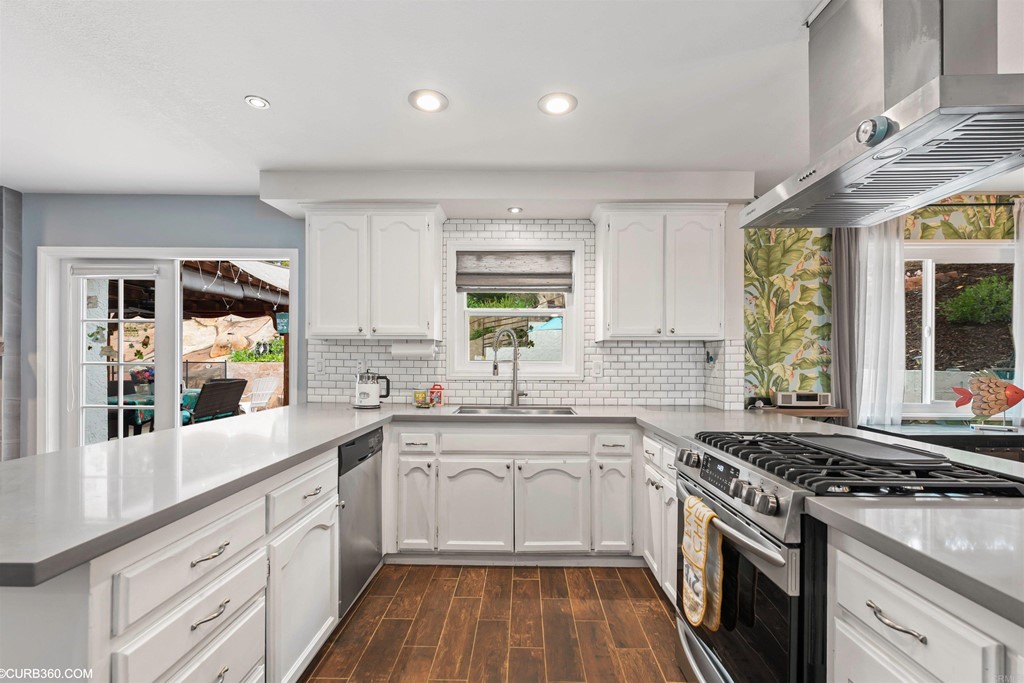 1179 Patricia Circle Vista, CA 92084 - Photo 9 of 48 a kitchen with a white cabinets stove and sink