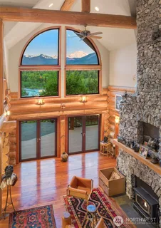 a living room filled with furniture and a floor to ceiling window