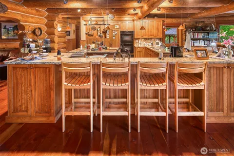 a dining room with furniture and a potted plant
