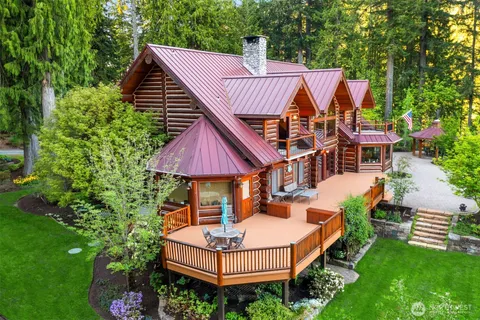 a view of a house with pool and chairs