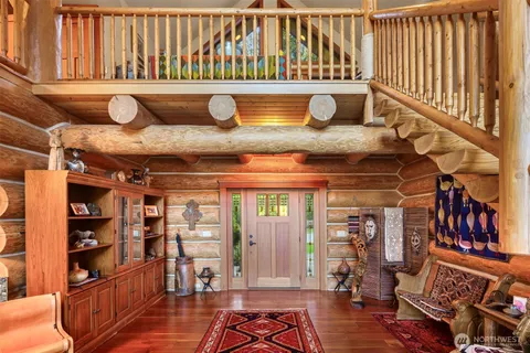 a living room with lots of furniture and a book shelf