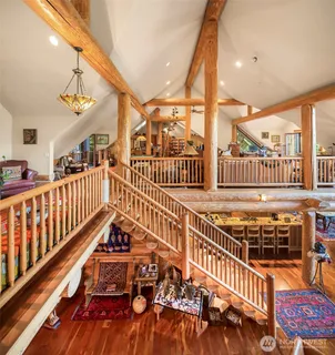 a bed sitting in a spacious bedroom next to a window