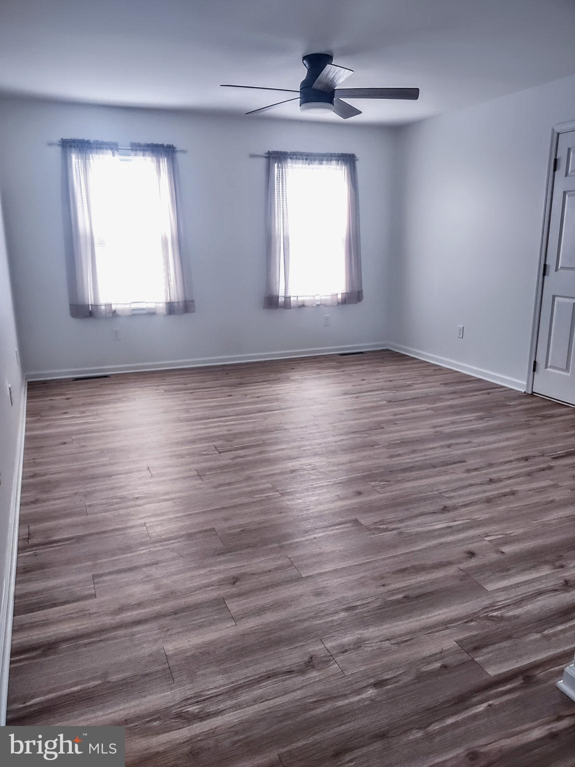 645 West 1st Street Boiling Springs, PA 17007 - Photo 12 of 23 an empty room with wooden floor and windows