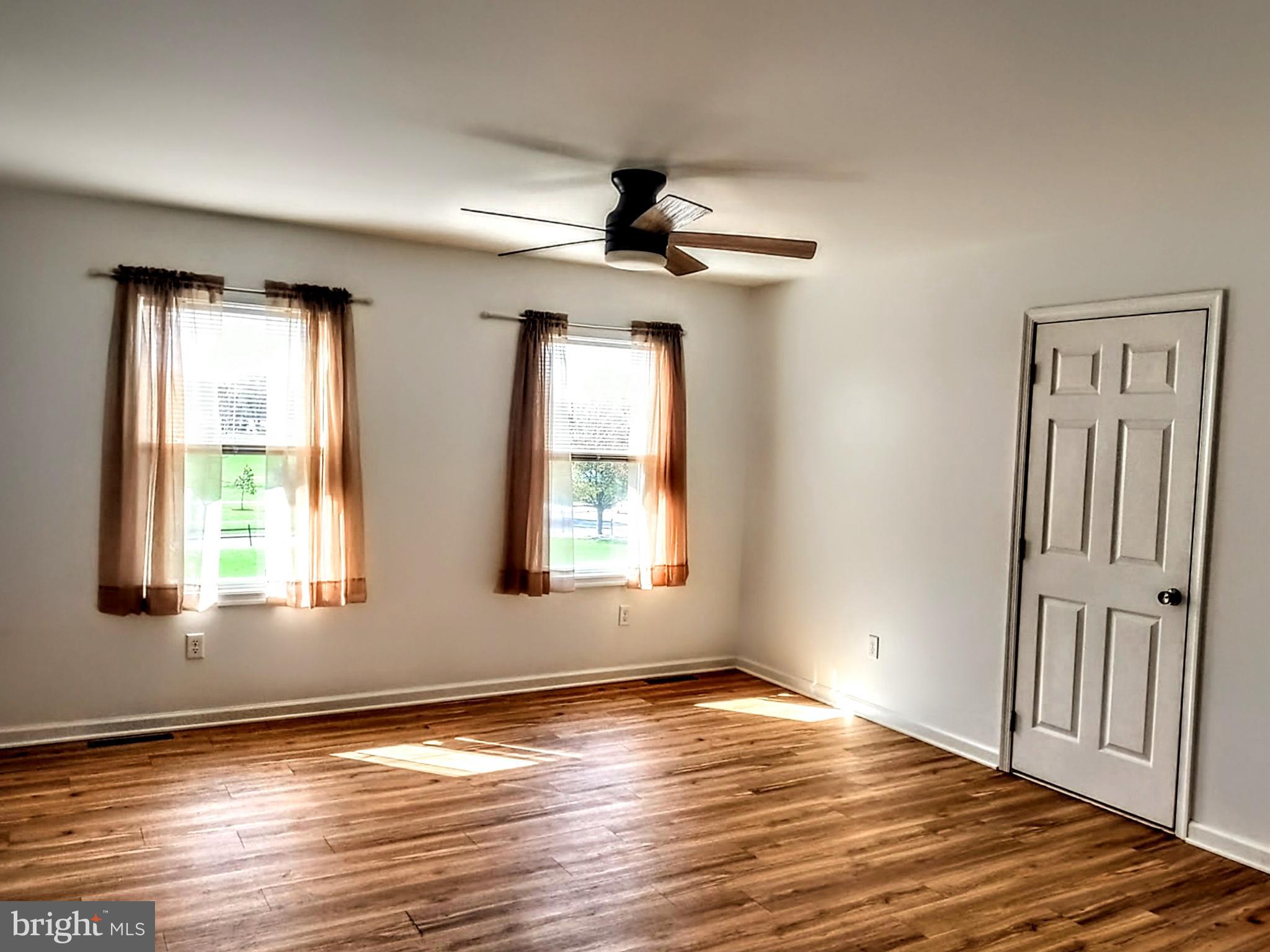 645 West 1st Street Boiling Springs, PA 17007 - Photo 14 of 23 a view of an empty room with wooden floor and a window