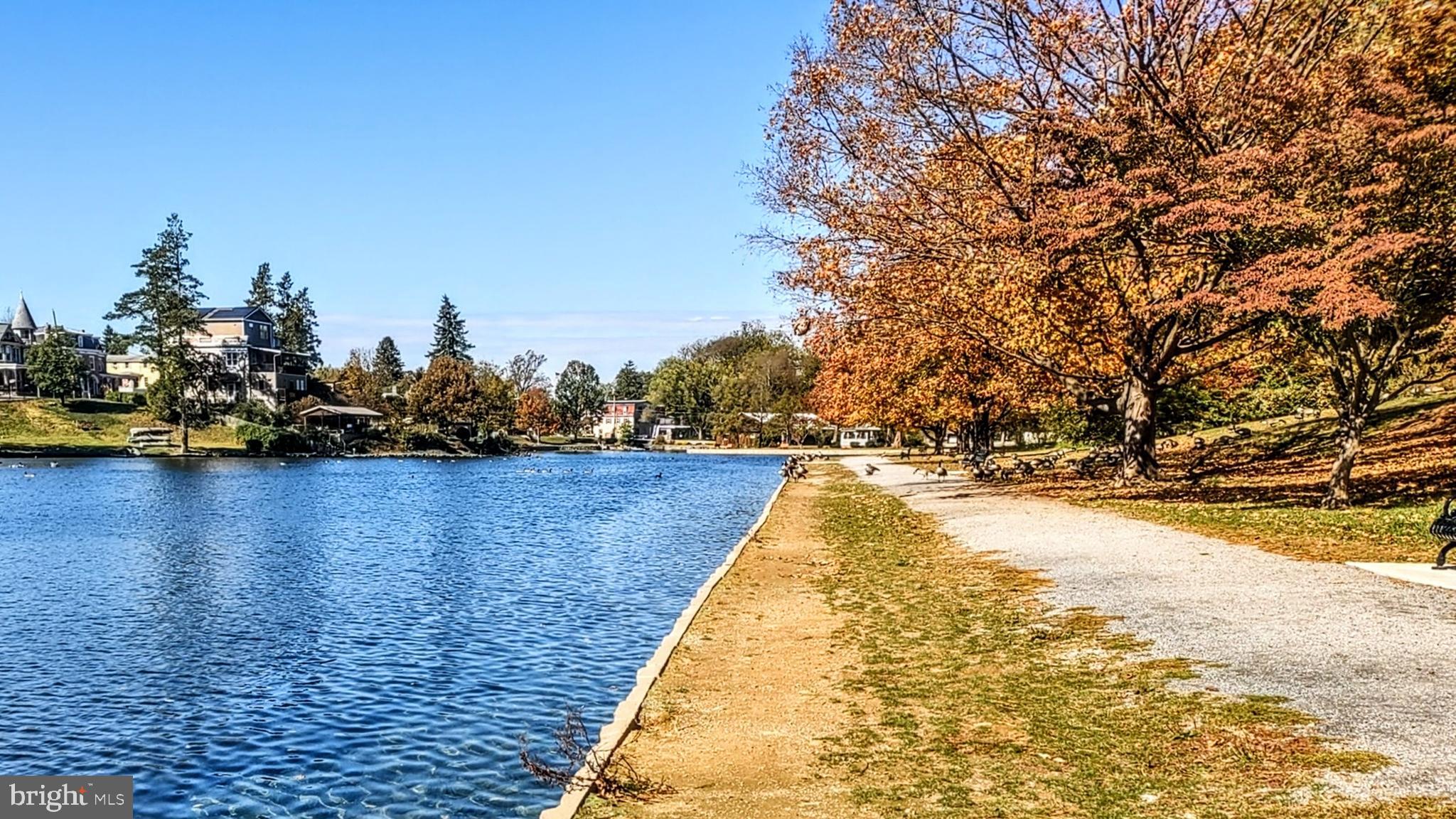 645 West 1st Street Boiling Springs, PA 17007 - Photo 23 of 23 a view of swimming pool with outdoor seating and lake in the background