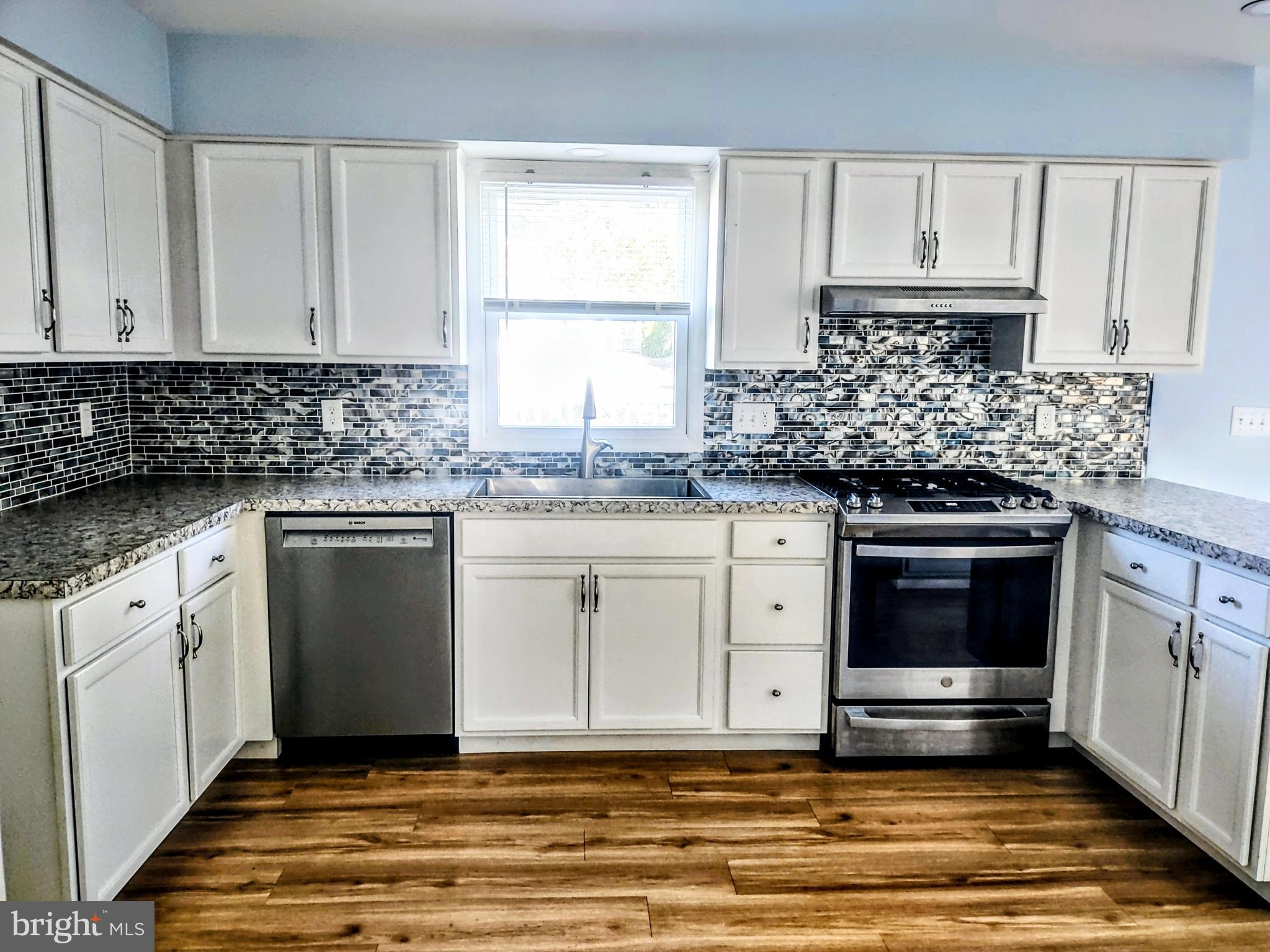 645 West 1st Street Boiling Springs, PA 17007 - Photo 5 of 23 a kitchen with granite countertop white cabinets and white appliances