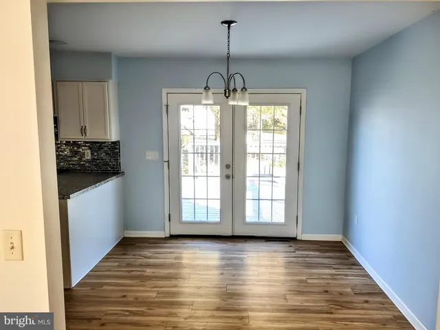 a view of a room with wooden floor and windows