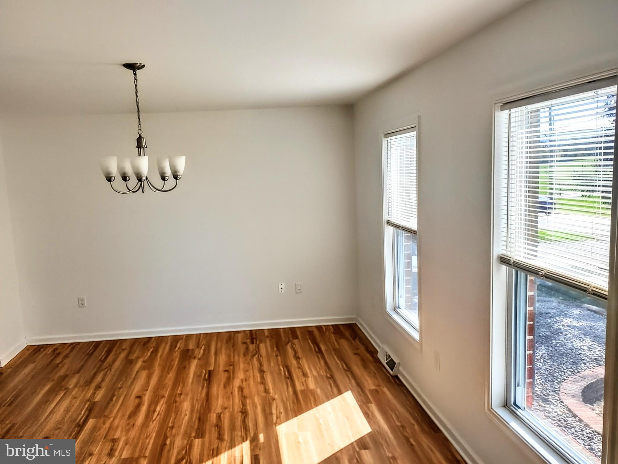 645 West 1st Street Boiling Springs, PA 17007 - Photo 9 of 23 a view of a room with wooden floor and windows