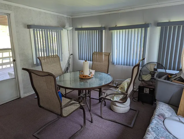 a dining room with furniture and wooden floor