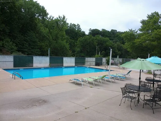 an outdoor space with swimming pool and furniture